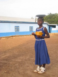 A student, with lunch container, arrives at Bagri Primary School