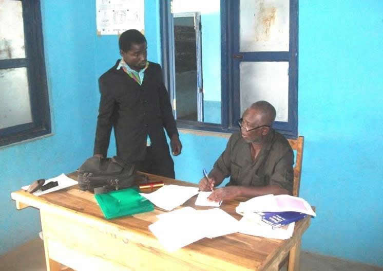 An inspector (seated) visits Gberi school